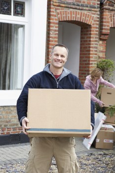 House removalists in Watford loading moving boxes into a van