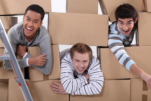 Removal team handling boxes during a Watford house move