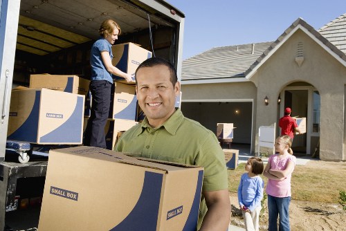 Professional movers handling stairs during a Watford apartment relocation